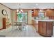 The eat-in kitchen features tile flooring, a chandelier, and views to the lush backyard at 115 Shoal Creek Dr, Sharpsburg, GA 30277