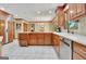 Spacious kitchen with stainless appliances, tile flooring, custom cabinetry, and center island at 115 Shoal Creek Dr, Sharpsburg, GA 30277