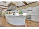 Open kitchen featuring a large island with modern appliances and white cabinetry at 115 Shoal Creek Dr, Sharpsburg, GA 30277