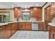 Kitchen with custom cabinets, stainless appliances, tile backsplash, and bright natural light at 115 Shoal Creek Dr, Sharpsburg, GA 30277