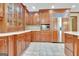 Kitchen with custom wood cabinetry, tile floor, stainless appliances, and granite countertops at 115 Shoal Creek Dr, Sharpsburg, GA 30277