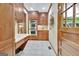 Butler's pantry with built in oven, cabinets, and granite countertops, next to entryway door at 115 Shoal Creek Dr, Sharpsburg, GA 30277