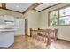Bright kitchen open to staircase and featuring white cabinets and granite countertops at 115 Shoal Creek Dr, Sharpsburg, GA 30277