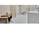 Bright laundry room with patterned floor, sewing machine, and washer at 115 Shoal Creek Dr, Sharpsburg, GA 30277