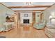 Comfortable living room with fireplace, hardwood flooring, and built-in cabinets at 115 Shoal Creek Dr, Sharpsburg, GA 30277