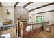 Large living area showcasing wood floors, a stone fireplace, and vaulted ceilings with wooden beams at 115 Shoal Creek Dr, Sharpsburg, GA 30277