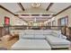 Open-concept living space with exposed beams and a large, comfortable white couch at 115 Shoal Creek Dr, Sharpsburg, GA 30277