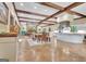 Expansive living room featuring wooden floors, beam ceilings, and an open kitchen concept at 115 Shoal Creek Dr, Sharpsburg, GA 30277