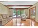 Spacious living room with backyard view, fireplace, and hardwood flooring at 115 Shoal Creek Dr, Sharpsburg, GA 30277