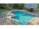 Aerial view of the in-ground pool and patio with cabana and lounge chairs at 115 Shoal Creek Dr, Sharpsburg, GA 30277