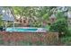 An inviting pool with brick border and lush landscaping offers a serene backyard retreat at 115 Shoal Creek Dr, Sharpsburg, GA 30277