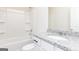 Bathroom features granite countertops, white cabinets, tub with shower head, and dual built in shelves at 435 Prescott Way, Villa Rica, GA 30180