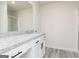 Modern bathroom with granite counters, white cabinets, and a large mirror at 448 Prescott Way, Villa Rica, GA 30180
