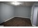 Unfinished basement with gray walls and wood flooring at 39 Mcferrin Cir, Riverdale, GA 30274