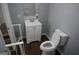 Modern bathroom featuring a white vanity, toilet and wood-look flooring at 39 Mcferrin Cir, Riverdale, GA 30274