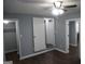 Bedroom with a ceiling fan and light fixture, mirrored closet doors, and doorway to additional rooms at 39 Mcferrin Cir, Riverdale, GA 30274
