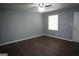 Bright bedroom with hardwood floors, a ceiling fan, and a large window that allows natural light at 39 Mcferrin Cir, Riverdale, GA 30274