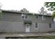 Back exterior view of home with stone and block, and a white door and windows at 39 Mcferrin Cir, Riverdale, GA 30274