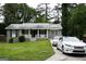 Charming grey brick home featuring a well-manicured lawn, front porch and a private driveway at 39 Mcferrin Cir, Riverdale, GA 30274