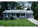 Charming one-story home with a well-maintained lawn and a welcoming front porch, ideal for relaxing outdoors at 39 Mcferrin Cir, Riverdale, GA 30274