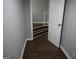 Hallway with hardwood floors leading to a stairway with a white door ajar at 39 Mcferrin Cir, Riverdale, GA 30274