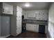 Kitchen featuring white cabinetry, dark hardware, grey countertops, dark wood flooring, and stainless appliances at 39 Mcferrin Cir, Riverdale, GA 30274