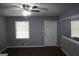 Bright living room featuring hardwood floors, a ceiling fan, and natural light streaming through large windows at 39 Mcferrin Cir, Riverdale, GA 30274