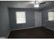Bright living room with hardwood floors, a ceiling fan, and a large window that allows natural light at 39 Mcferrin Cir, Riverdale, GA 30274
