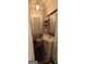 Cozy bathroom featuring a vanity with white cabinets, a window, and a framed mirror at 1270 M L King Jr Sw Dr, Atlanta, GA 30314