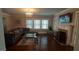 Bright living room featuring hardwood floors, a fireplace, and a large sectional sofa at 1270 M L King Jr Sw Dr, Atlanta, GA 30314