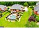 Beautiful backyard view features a private pool and patio seating with mature landscaping around the brick home at 713 Birkdale Blvd, Carrollton, GA 30116