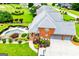 Aerial view of a home with lush landscaping, a spacious patio, and backyard pool at 713 Birkdale Blvd, Carrollton, GA 30116