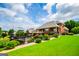 Landscaped backyard showcasing lush green lawn, mature trees, and brick home exterior at 713 Birkdale Blvd, Carrollton, GA 30116