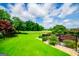 Expansive green backyard with a manicured lawn, black fence, and landscaping at 713 Birkdale Blvd, Carrollton, GA 30116