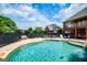 Backyard featuring a pristine pool, wrought iron fence, and manicured landscaping at 713 Birkdale Blvd, Carrollton, GA 30116