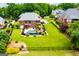 Aerial view of a backyard featuring a luxurious pool, lush lawn, and neatly landscaped garden with privacy fence at 713 Birkdale Blvd, Carrollton, GA 30116