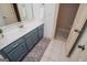 Bathroom featuring a blue vanity with a white countertop and neutral tile flooring at 713 Birkdale Blvd, Carrollton, GA 30116