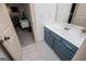 Clean bathroom featuring a blue vanity, white countertop, and tile flooring at 713 Birkdale Blvd, Carrollton, GA 30116