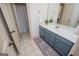 Bright bathroom showcasing a blue vanity, white countertop, and tiled floors at 713 Birkdale Blvd, Carrollton, GA 30116