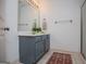 Bathroom with blue vanity and a large mirror, as well as modern lighting and neutral walls at 713 Birkdale Blvd, Carrollton, GA 30116