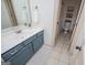 Well-lit bathroom with a white countertop, blue vanity, and tiled flooring at 713 Birkdale Blvd, Carrollton, GA 30116