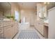 Bright bathroom with dual vanities, a corner tub, and a decorative chandelier at 713 Birkdale Blvd, Carrollton, GA 30116