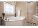Elegant bathroom with a corner soaking tub, decorative window, and a chandelier at 713 Birkdale Blvd, Carrollton, GA 30116