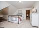 Neutral bedroom with a black metal frame bed, white walls, and carpeted flooring, leading to an ensuite bathroom at 713 Birkdale Blvd, Carrollton, GA 30116