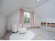 Attic bedroom featuring soft carpet, natural light, and a cozy seating area at 713 Birkdale Blvd, Carrollton, GA 30116