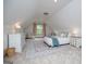 Bright attic bedroom with a sloped ceiling, soft carpet, and ample natural light at 713 Birkdale Blvd, Carrollton, GA 30116