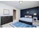 Stylish bedroom showcasing a blue accent wall, soft carpet, and natural light at 713 Birkdale Blvd, Carrollton, GA 30116