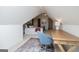 Attic bedroom featuring a desk, chair, neutral carpet, and an arched window above a daybed that adds charm to the space at 713 Birkdale Blvd, Carrollton, GA 30116