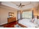 Bright bedroom featuring a tray ceiling, ceiling fan, and matching wood furniture at 713 Birkdale Blvd, Carrollton, GA 30116