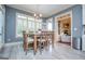 Charming dining area with wood table, seating six, and natural light from large windows at 713 Birkdale Blvd, Carrollton, GA 30116